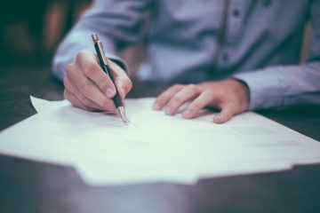 A men writing on some papers